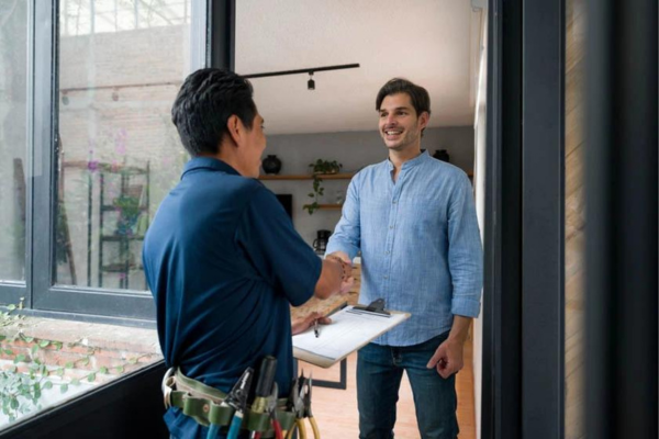 A technician meets a homeowner to discuss water damage restoration in Doral, Florida, focusing on professional solutions.