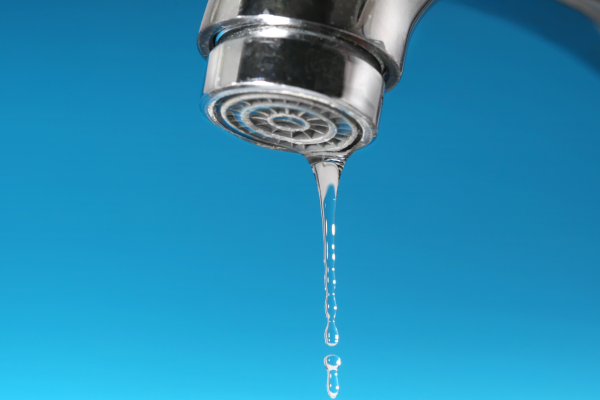 Faucet dripping to prevent frozen pipes during cold winter temperatures and avoid pipe bursts