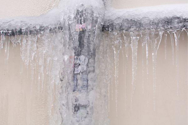 Frost-covered pipes in winter, a common warning sign that pipes are at risk of freezing and bursting