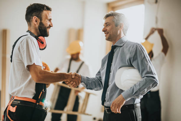 A contractor shakes hands with a business owner in West Palm Beach, symbolizing professional water damage restoration services.