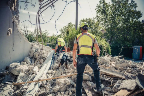Restoration workers assessing structural damage in Brooklyn, New York, during a water damage restoration project.