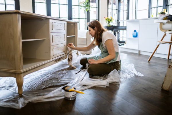 Water-damaged furniture being repaired by a homeowner.