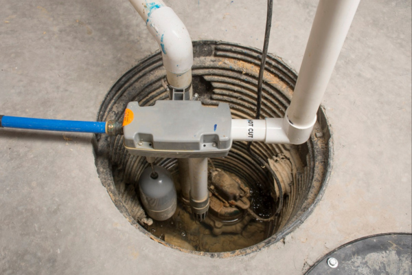 Sump pump installed in a basement to prevent water damage.