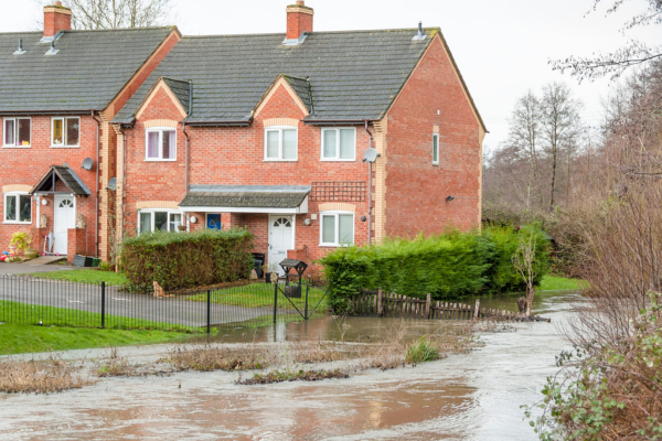 Floodwater surrounding a home in a flood-prone area.