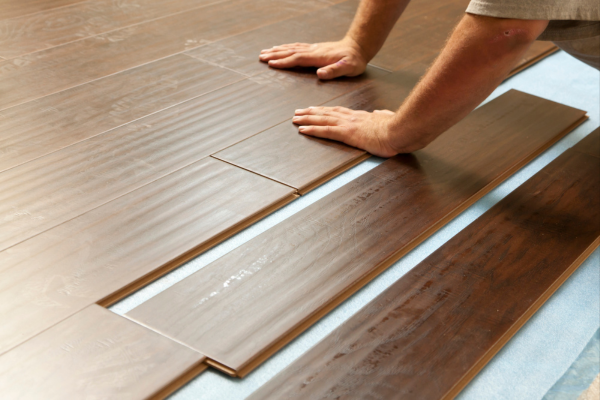 Professional installation of laminate flooring with attention to proper sealing and underlayment