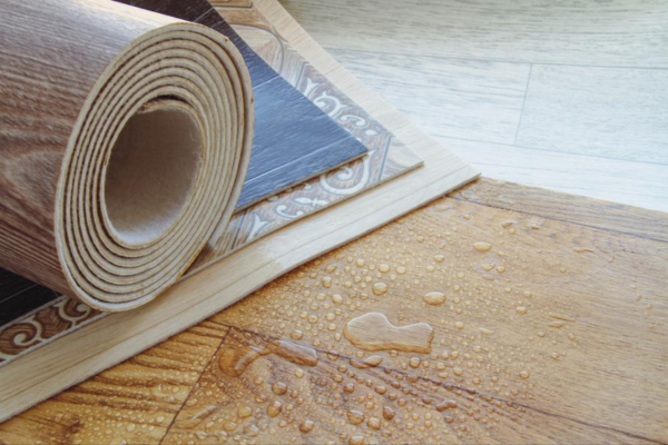 Various waterproof flooring options, including vinyl planks and laminate with water droplets, highlighting water resistance.