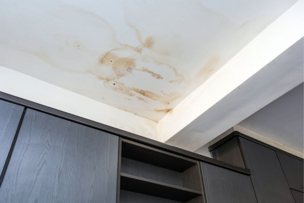 Ceiling with visible water stains indicating potential damage.