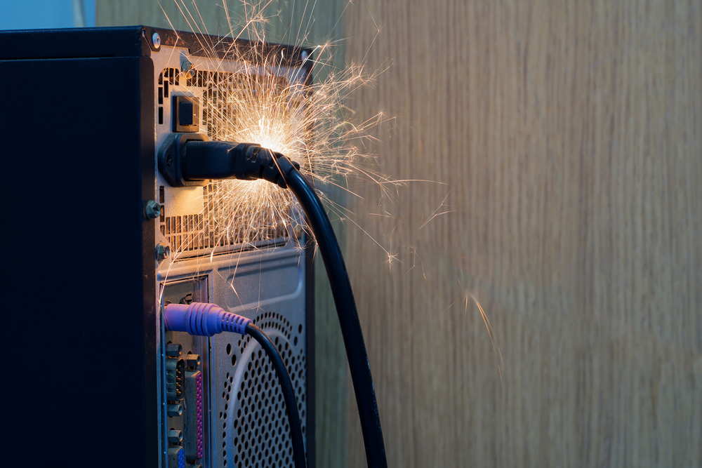 Electrical sparks and damage near an outlet with exposed wiring.