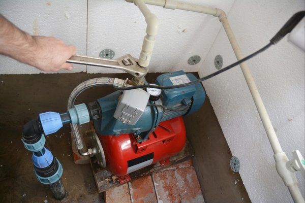 Man working on sump pump after failure